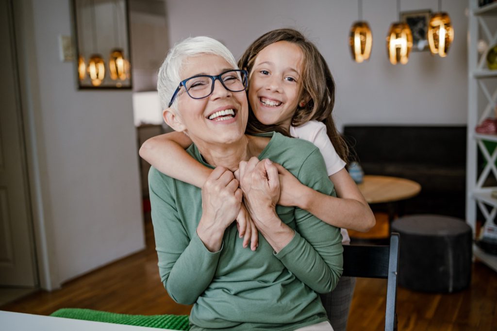 Cute girl hugging her grandmother