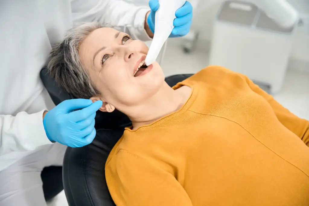 Woman with digital scanner in mouth